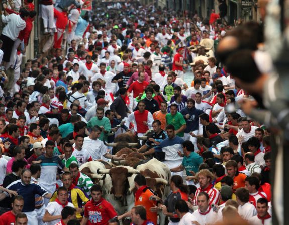 Fighting bulls from the El Ventorrillo ranch run in the middle of a street packed with thousands of runners on July 9, 2009 in Pamplona, Spain.