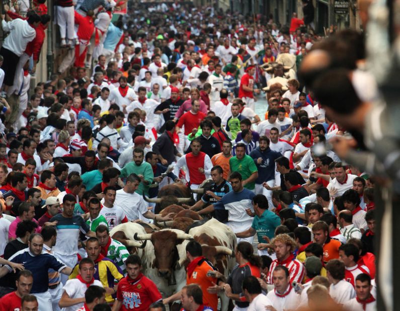 Fighting bulls from the El Ventorrillo ranch run in the middle of a street packed with thousands of runners on July 9, 2009 in Pamplona, Spain.