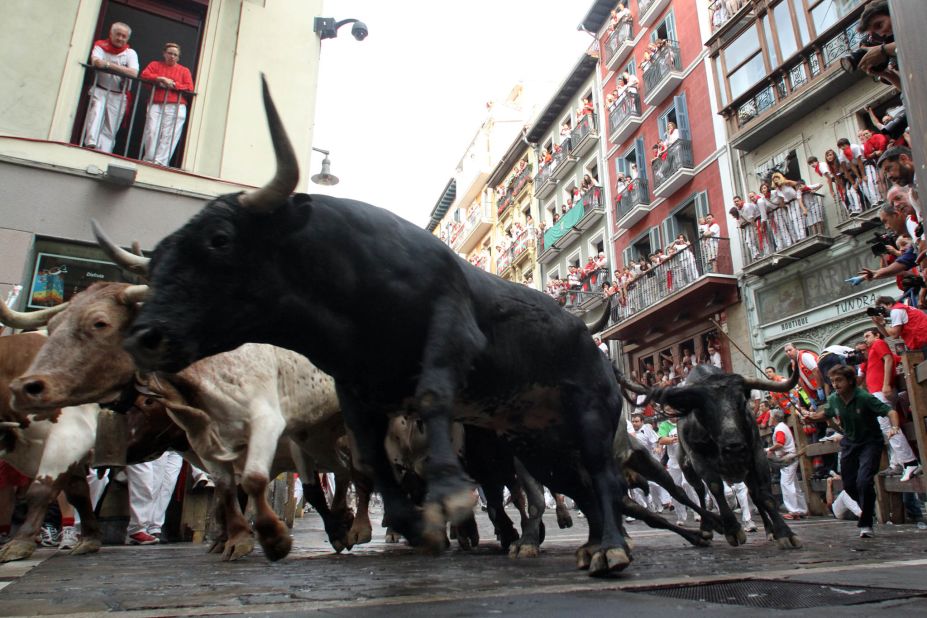 Bulls run around La Curva in Pamplona on July 11, 2010.