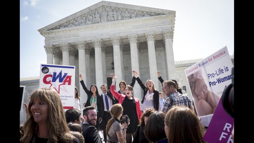 The legal team representing craft-store chain Hobby Lobby Stores Inc. celebrates on the steps of the U.S. Supreme Court after a ruling is announced in Washington, D.C., U.S., on Monday, June 30, 2014. The Supreme Court dealt a blow to President Barack Obama's health-care law, ruling that closely held companies can claim a religious exemption from the requirement that they offer birth-control coverage in their worker health plans. 