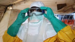 A picture taken on June 28, 2014 shows a member of Doctors Without Borders (MSF) putting on protective gear at the isolation ward of the Donka Hospital in Conakry, where people infected with the Ebola virus are being treated. The World Health Organization has warned that Ebola could spread beyond hard-hit Guinea, Liberia and Sierra Leone to neighbouring nations, but insisted that travel bans were not the answer. To date, there have been 635 cases of haemorrhagic fever in Guinea, Liberia and Sierra Leone, most confirmed as Ebola. A total of 399 people have died, 280 of them in Guinea.
