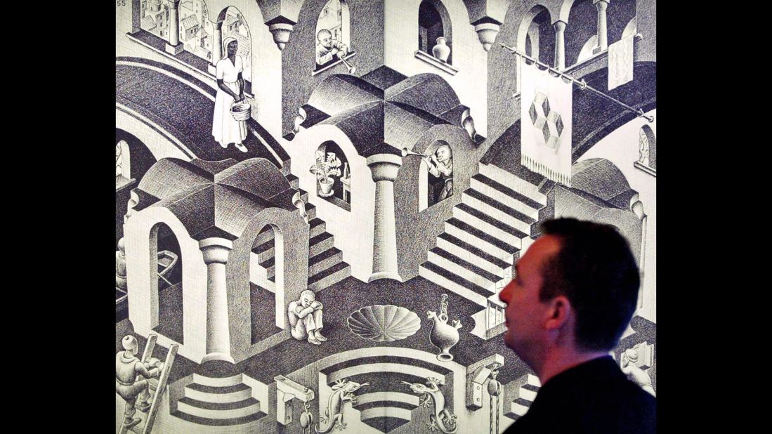A man looks at Dutch artist M.C. Escher's artwork "Hol en Bol" (1955), displayed at the Escher Museum.
