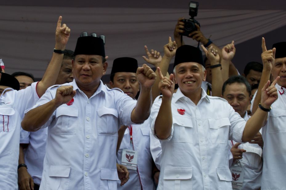 Presidential candidate Prabowo Subianto, at left, and running mate Hatta Rajasa wave to supporters during a campaign rally on June 22. Prabowo was a special forces commander under the regime of his former father-in-law Suharto. 