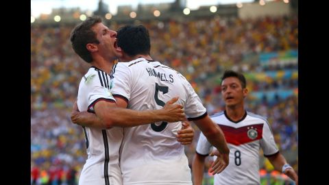 Mats Hummels celebrates with Mueller, left, and Oezil after his first-half header gave Germany a 1-0 lead.