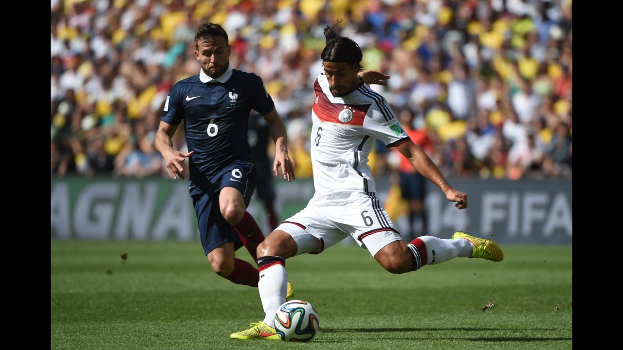 French midfielder Yohan Cabaye, left, looks on as Khedira kicks the ball in the first half.
