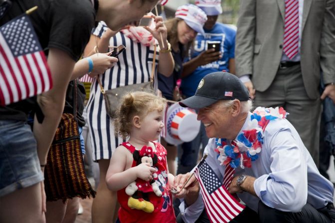 U.S. Vice President Joe Biden greets a young spectator as he marches in an Independence Day parade in Philadelphia.