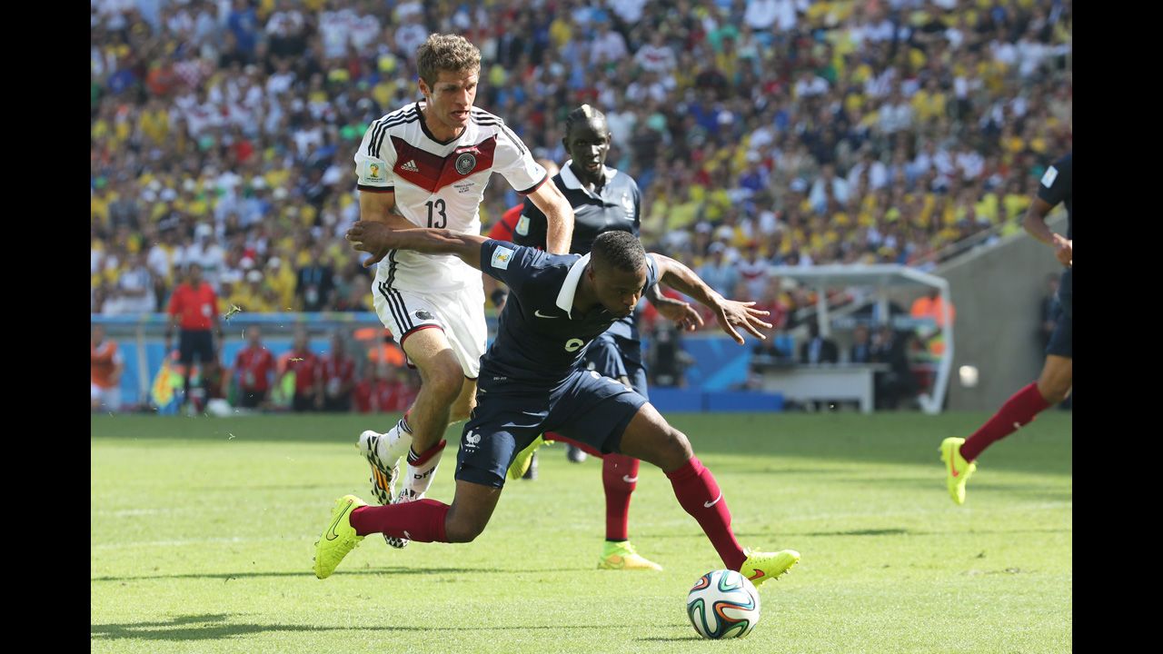 Germany's Thomas Mueller, left, and France's Patrice Evra compete for the ball in the second half.