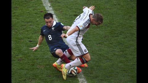 French midfielder Mathieu Valbuena attempts to dispossess Schweinsteiger.