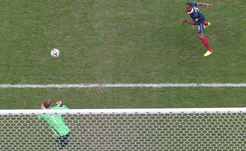 Evra heads the ball toward German goalkeeper Manuel Neuer.