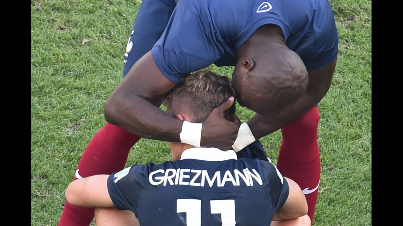 France's Eliaquim Mangala consoles teammate Antoine Griezmann after the match.