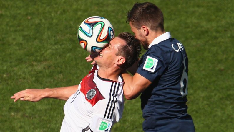 Germany's Miroslav Klose, left, and France's Yohan Cabaye go up for a header.