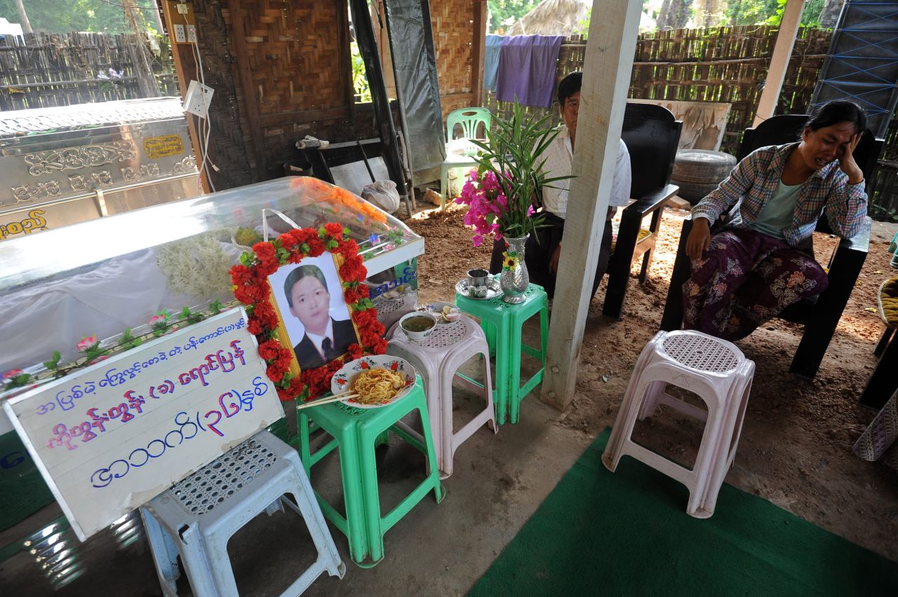 Family members grieve next to the man's coffin.