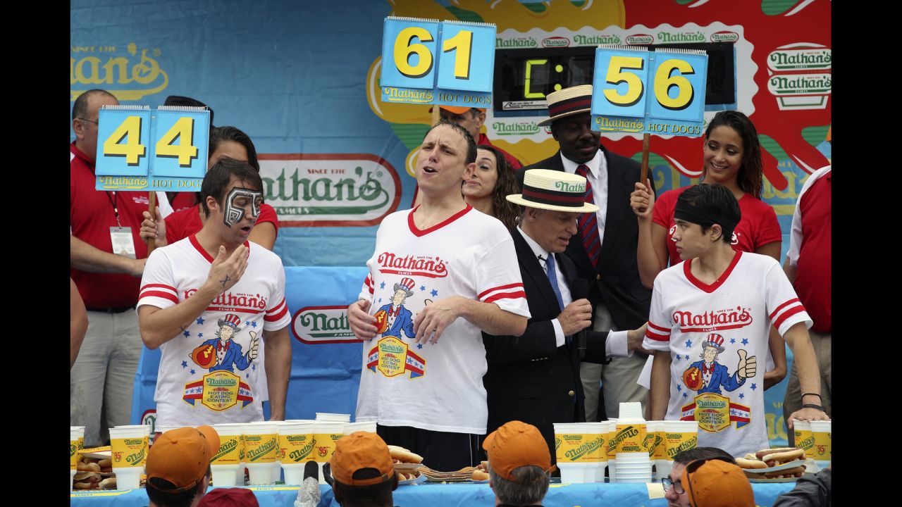 Chestnut, center, reacts next to fellow competitors Tim Janus, left, and Matt Stonie after the competition.