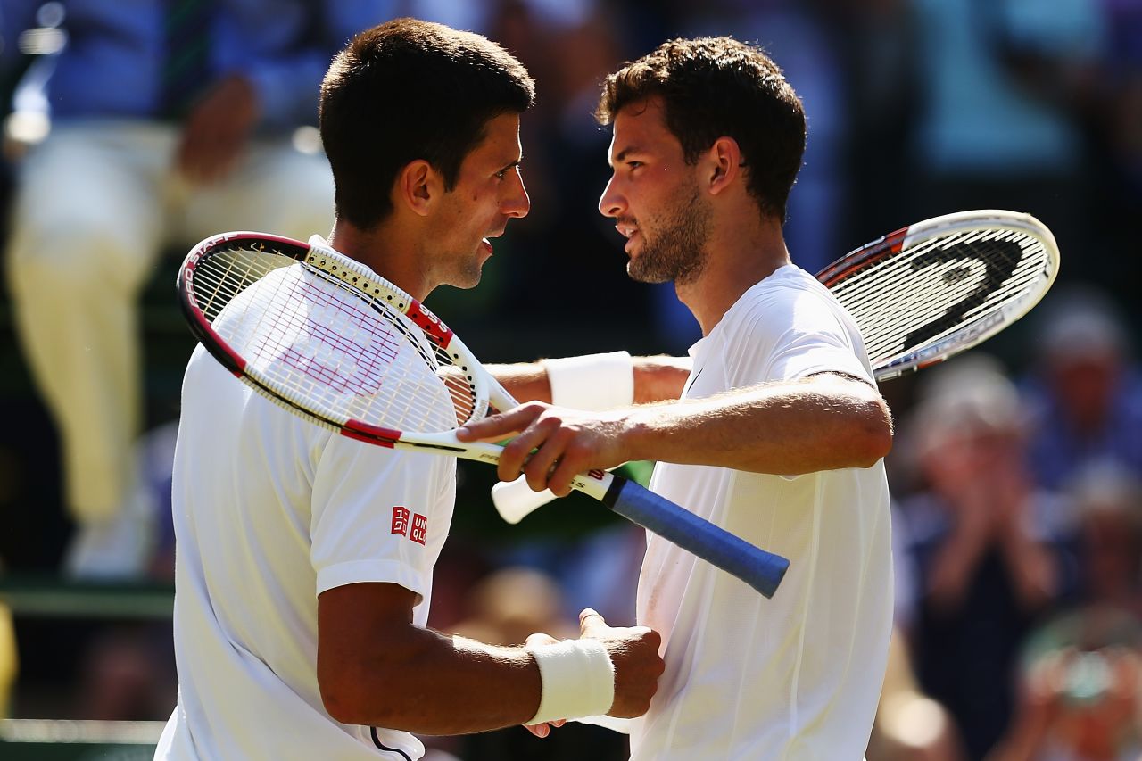 Djokovic and Dimitrov embrace at the end of their Wimbledon semifinal match.