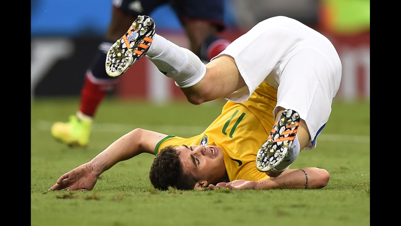 Brazilian midfielder Oscar falls down. 