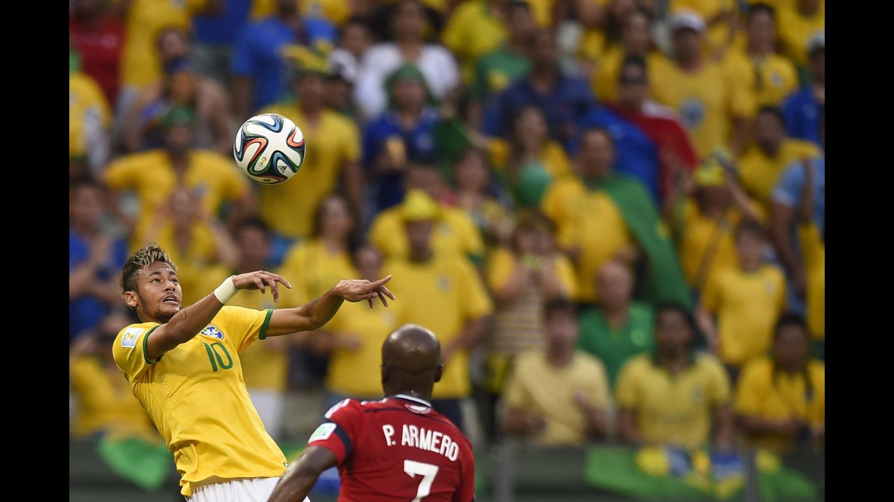 Brazilian forward Neymar heads the ball past Colombian defender Pablo Armero. 