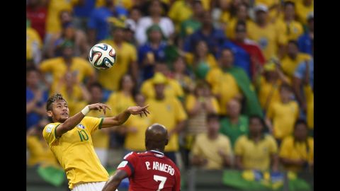 Brazilian forward Neymar heads the ball past Colombian defender Pablo Armero. 