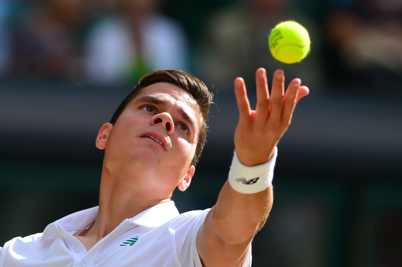 Milos Raonic serves during the first set his semifinal encounter with Roger Federer at Wimbledon. The young Canadian showed nerves early on but steadied as the first set went on.