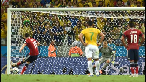 Colombia midfielder James Rodriguez, left, shoots and scores a penalty. 