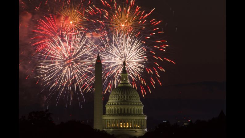 Fireworks illuminate the sky over the U.S. Capitol and the Washington Monument.