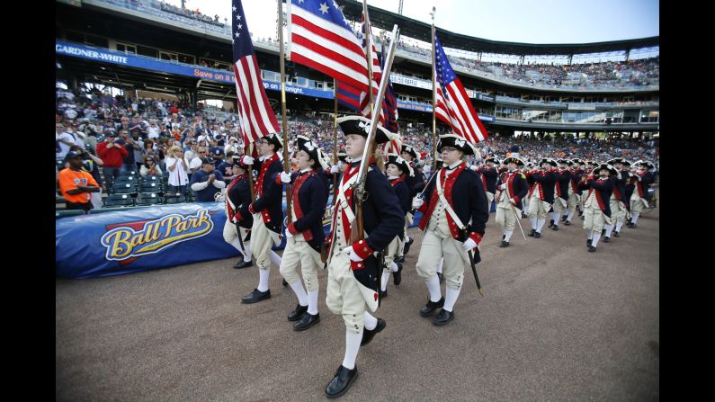 A fife and drum corps entertains the fans before a Detroit Tigers baseball game.