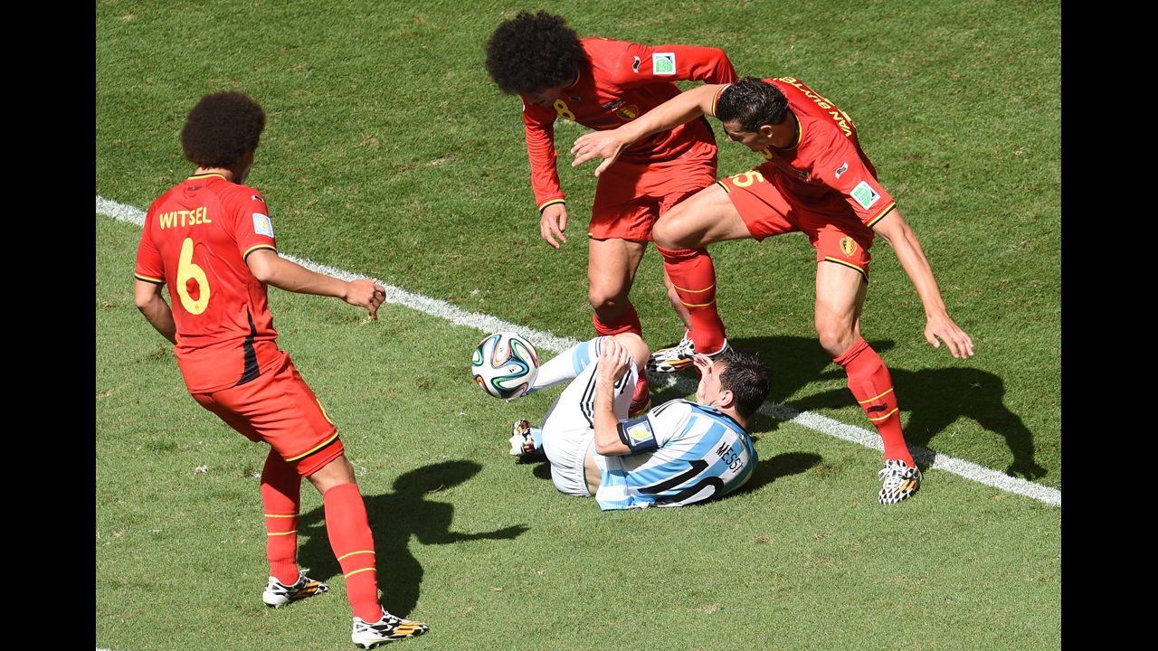 Messi falls amid Belgium players.