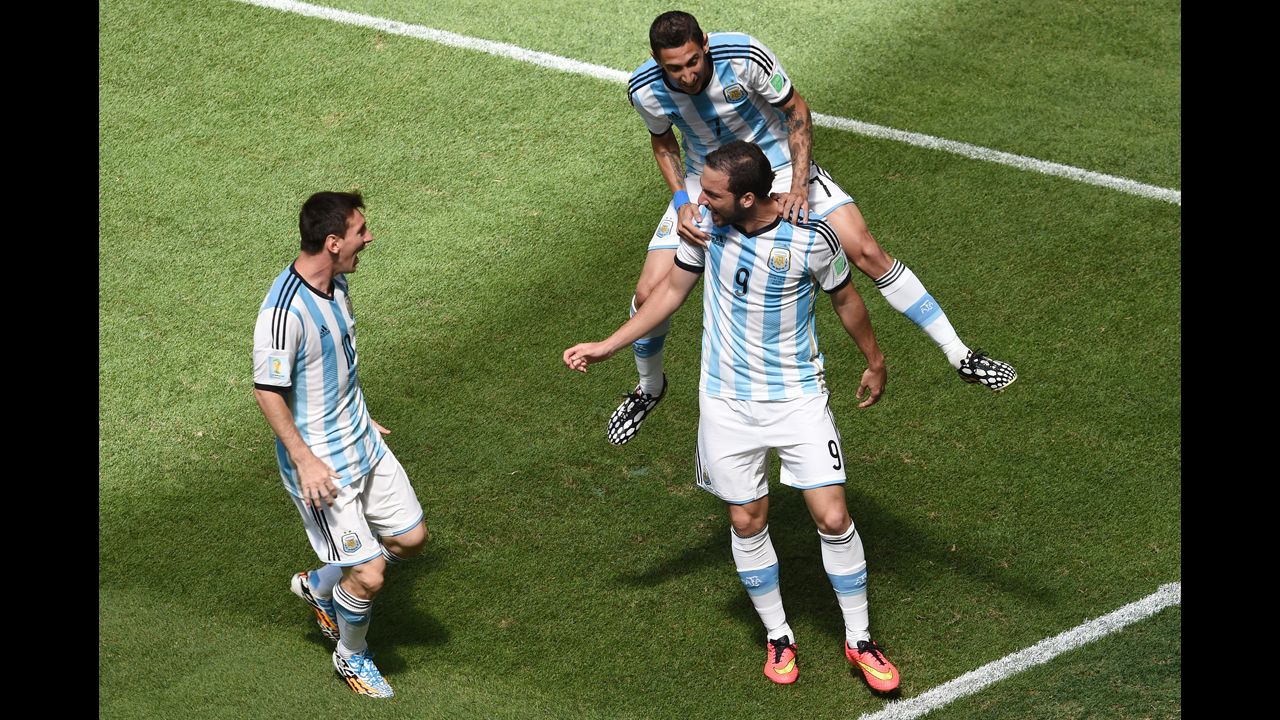 Argentina forward Gonzalo Higuain, right, celebrates with di Maria, top, and Messi, left, after scoring.