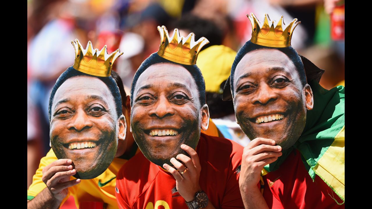 Fans hold up cutouts of Brazilian legend Pele prior to the match between Argentina and Belgium.