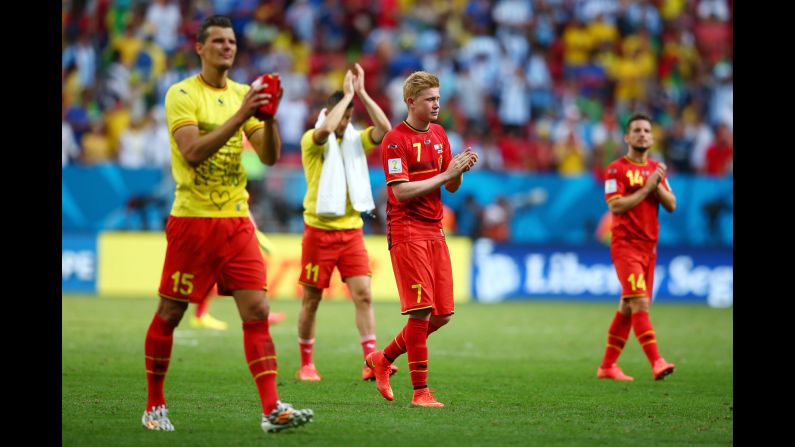 Daniel Van Buyten, left, and Kevin De Bruyne of Belgium acknowledge the fans after their loss 1-0 loss to Argentina.