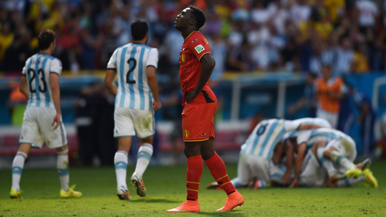 Belgium forward Romelu Lukaku walks away while Argentina celebrates.