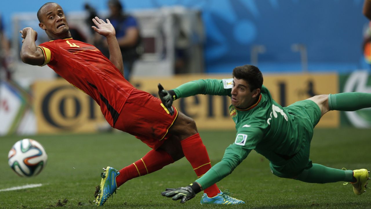 Belgium defender and captain Vincent Kompany, left, and Belgium's goalkeeper Thibaut Courtois eye the ball. 