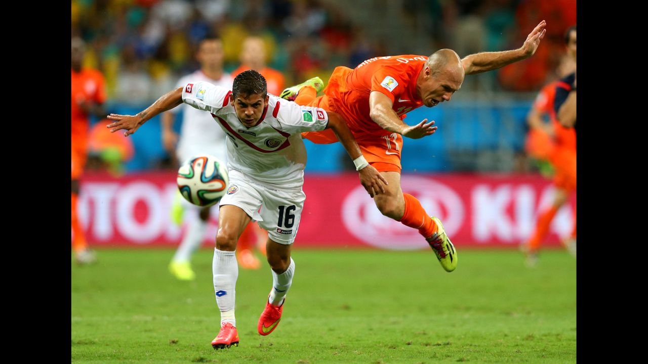 Cristian Gamboa of Costa Rica and Arjen Robben of the Netherlands compete for the ball. 