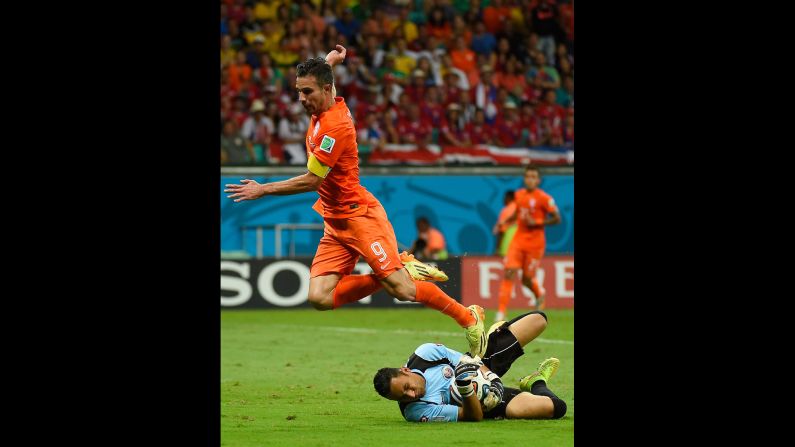 Netherlands forward and captain Robin van Persie, left, fails to score past Costa Rica goalkeeper Keylor Navas.
