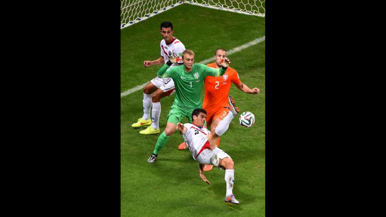 Johnny Acosta of Costa Rica attempts a shot on goal against goalkeeper Jasper Cillessen and Ron Vlaar of the Netherlands. 
