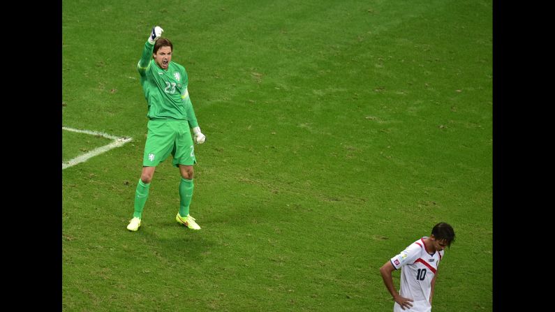 Netherlands goalkeeper Tim Krul celebrates after making a save on a kick from Costa Rica forward and captain Bryan Ruiz, right, during the penalty shootout.