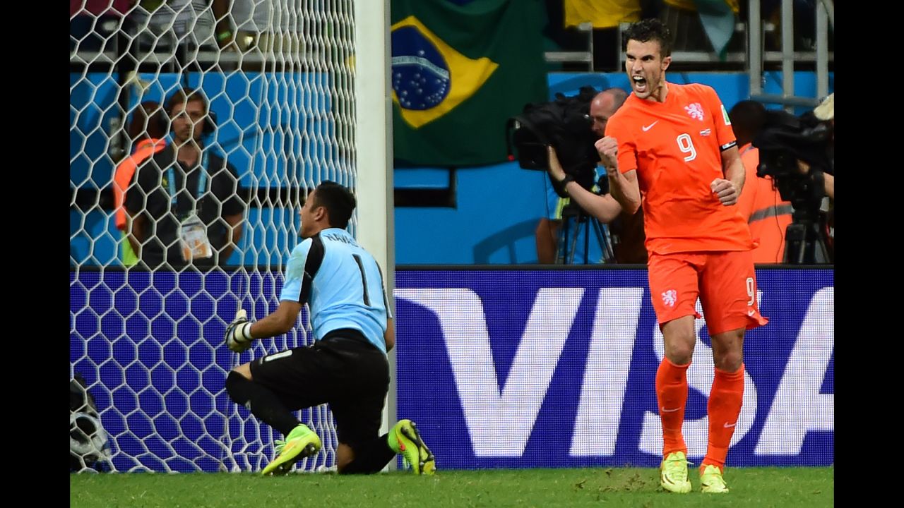 Netherlands forward and captain Robin van Persie celebrates after scoring past Costa Rica goalkeeper Keylor Navas. 