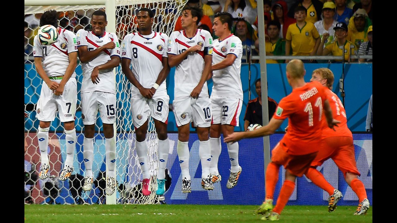 Netherlands forward Arjen Robben, second right, shoots a free kick toward Costa Rica's wall. 