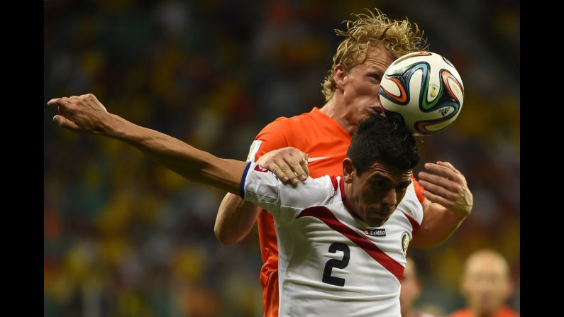 Costa Rica defender Johnny Acosta (front) vies with Netherlands' forward Dirk Kuyt. 