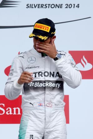 Lewis Hamilton wipes away a tear after his emotional victory at the British Grand Prix at Silverstone.