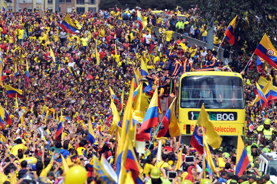 The Colombian team bus edges through massive crowds who greeted them in the capital Bogota. 