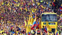 The Colombian team bus edges through massive crowds who greeted them in the capital Bogota.