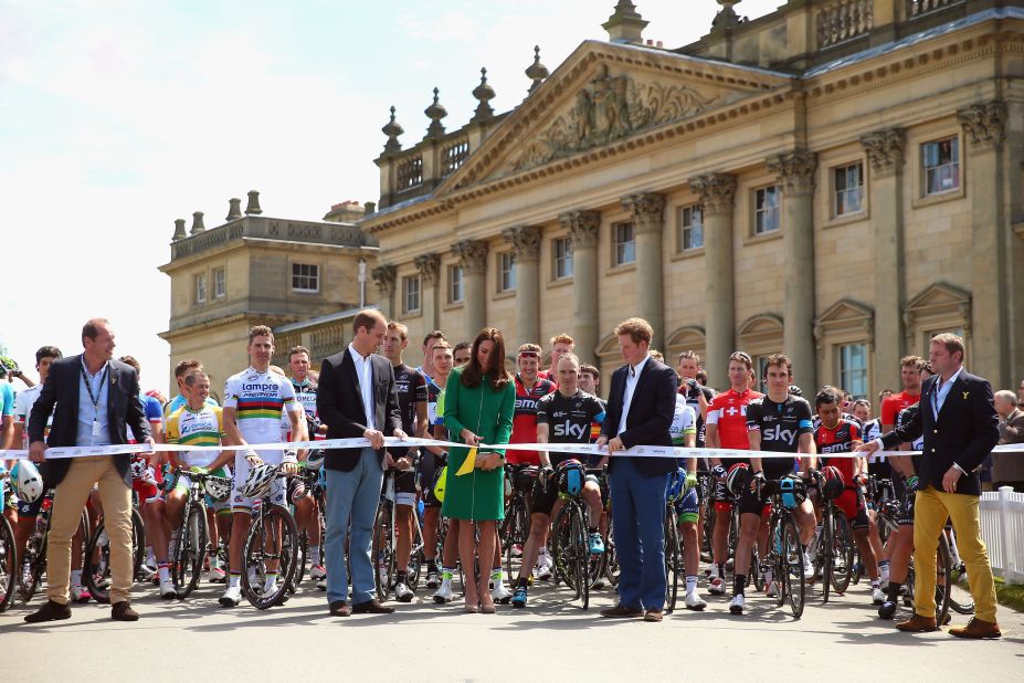 The Duke and Duchess of Cambridge inaugurate the opening stage of the Tour by ceremoniously cutting the ribbon in front of the racers. 