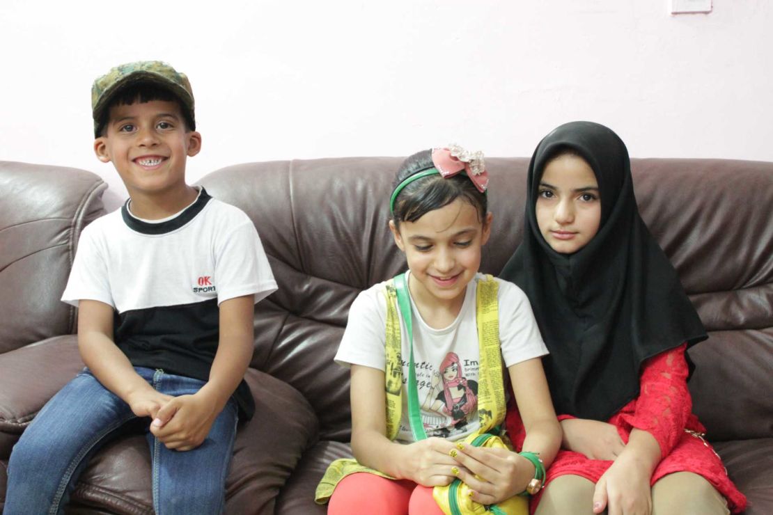 Six-year-old Ali, left, who lost his father in a bomb attack in Sadr City, sits alongside sister Baneen, center, 11, and Baneen's friend Hajer, 11, whose father was assassinated when she was only four years old.