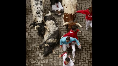 Some bulls fall as they race through Pamplona's narrow streets on July 7.