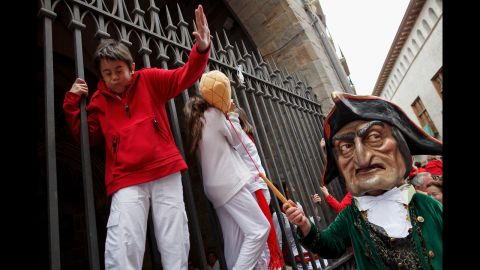 A child is playfully hit July 7 during the Giants and Big Heads Parade, which is also a traditional part of the San Fermin festival.