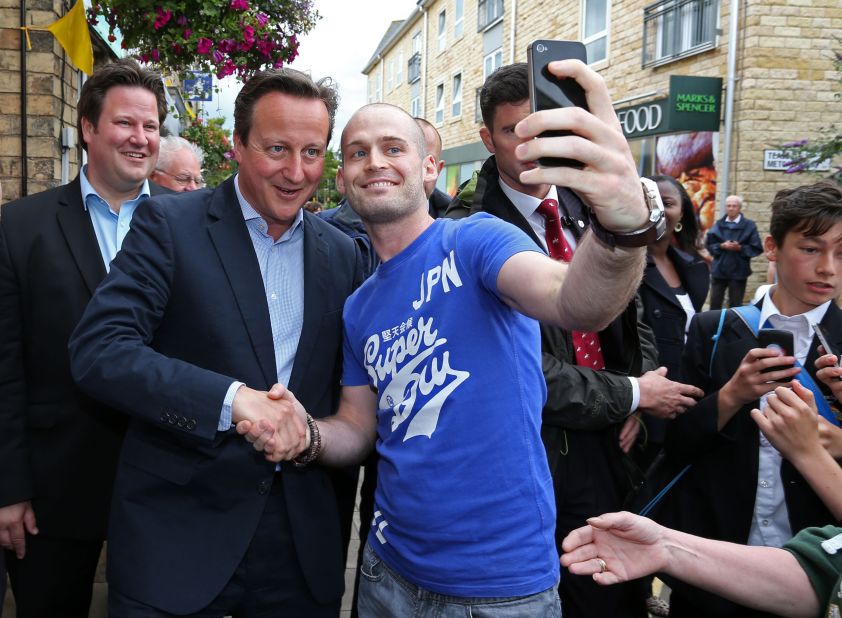 British Prime Minister, David Cameron, gets involved in the 'selfie' trend as he poses with a Tour de France fan. 