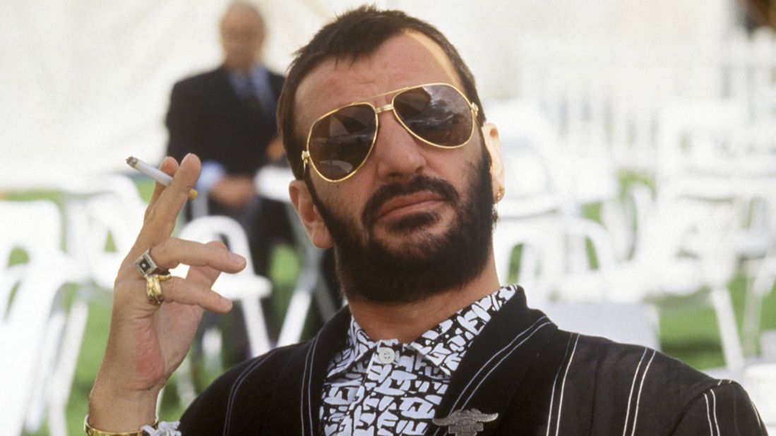 Ringo Starr posed, holding cigarette, wearing sunglasses in 1987. Ringo famously sang, "it don't come easy," but at moments like this he sure makes it look easy.