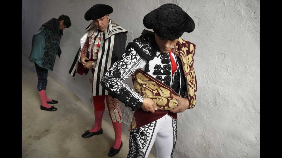 Bullfighter Miguel Abellan adjusts his capote before the ritual entrance to the arena on July 7.