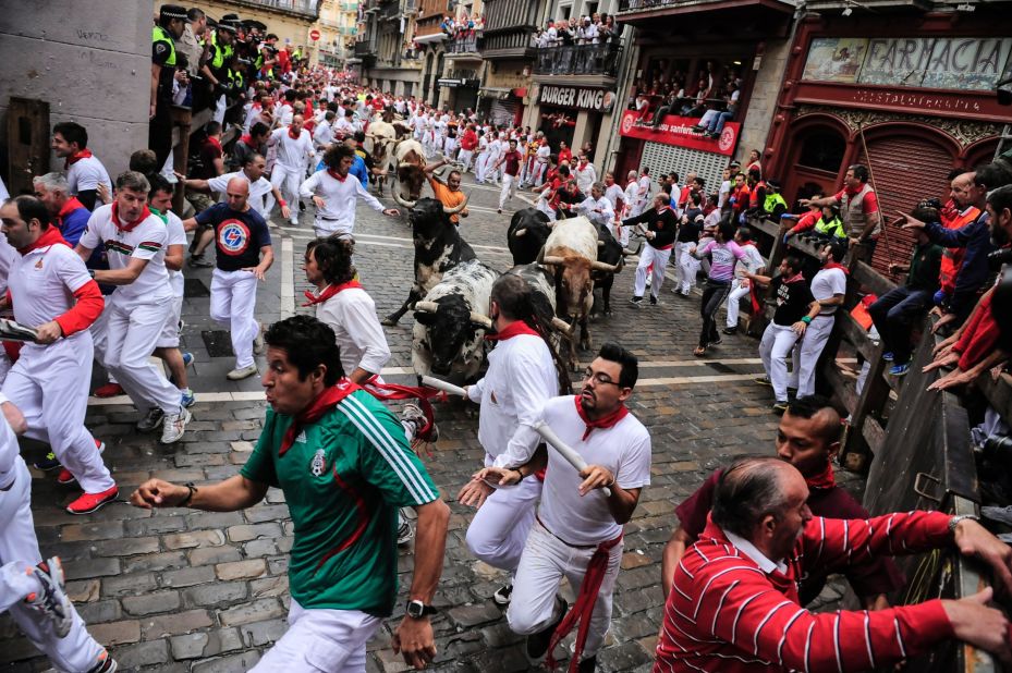 Revelers take part in the bull run on July 7.