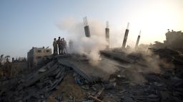 Palestinians inspect damaged houes after an Israeli missile strike hit Gaza City on July 8, 2014 . The Israeli air force launched dozens of raids on the Gaza Strip overnight after massive rocket fire from the enclave pounded southern Israel, leaving 17 people injured, sources said. AFP PHOTO / MAHMUD HAMS (Photo credit should read MAHMUD HAMS/AFP/Getty Images)